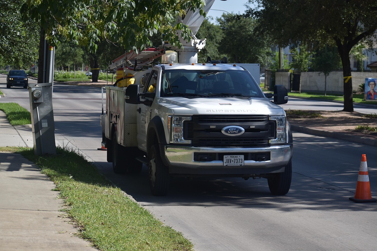 Tree service truck and chipper parked beside a suburban home